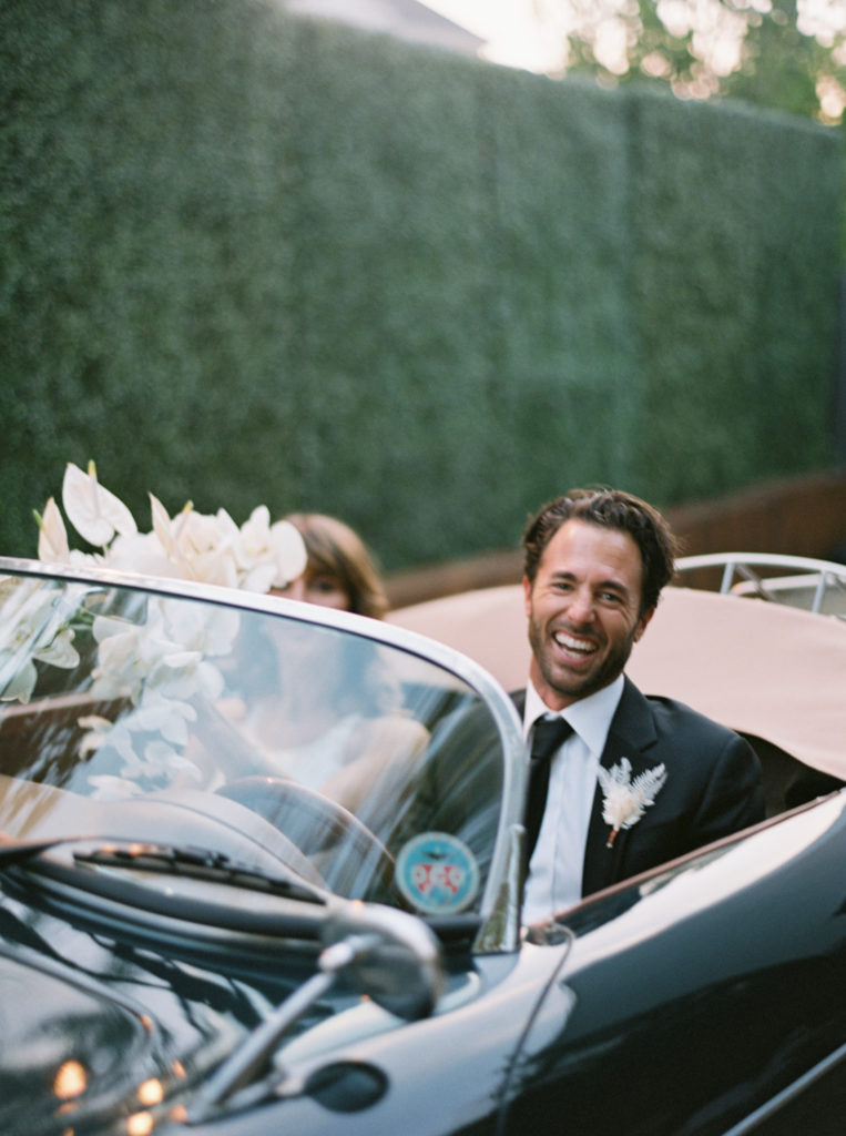 Groom and bride laughing in car in Los Angeles by JS Rhos