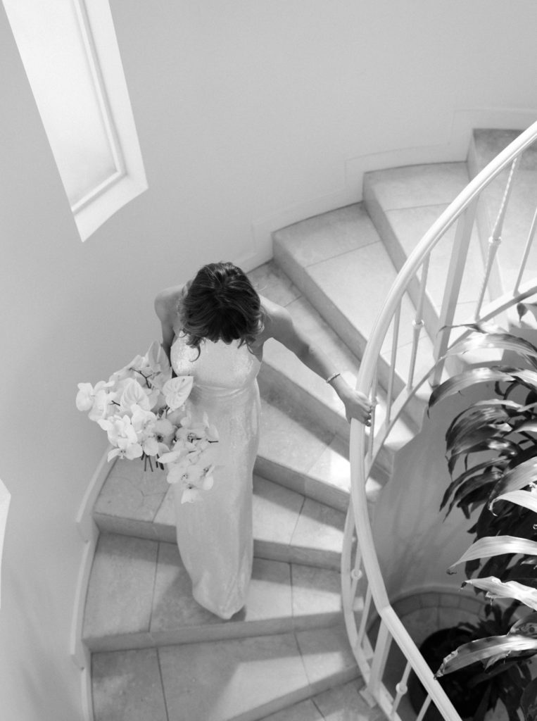 Bride walking down stairs in Sunset Marquis, Los Angeles by JS Rhos