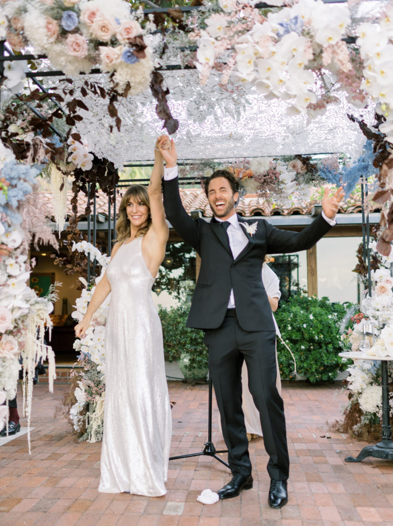 Bride and groom cheering after ceremony Los Angeles